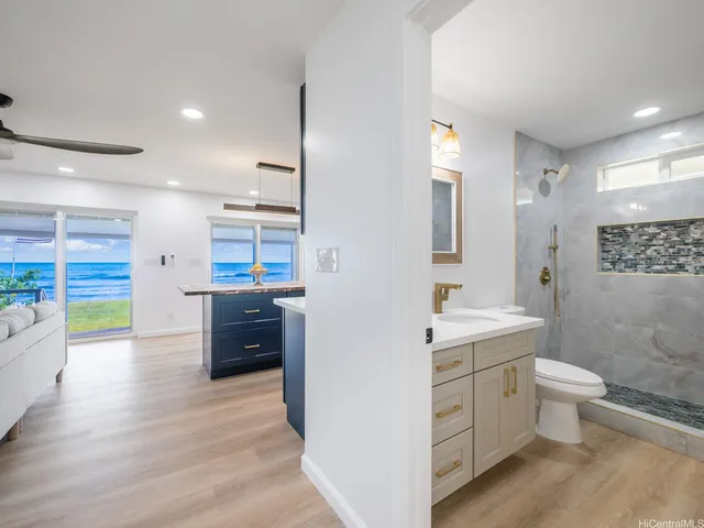 a bathroom with a sink a toilet and shower