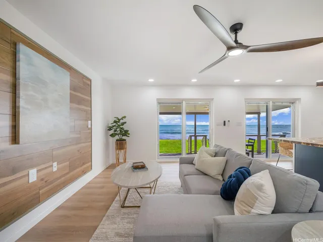 a living room with furniture and a potted plant