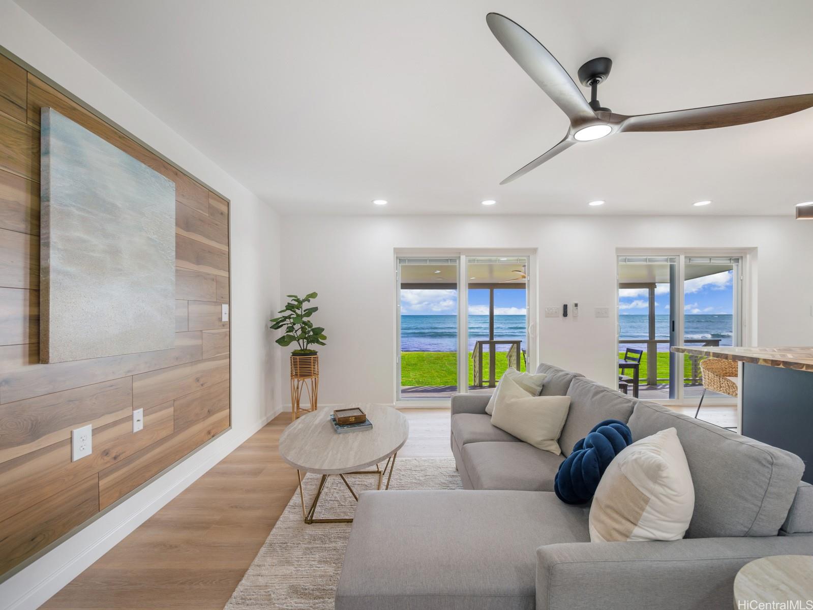 91-481 Ewa Beach Road, Unit C Ewa Beach, HI 96706 - Photo 3 of 25 a living room with furniture and a potted plant