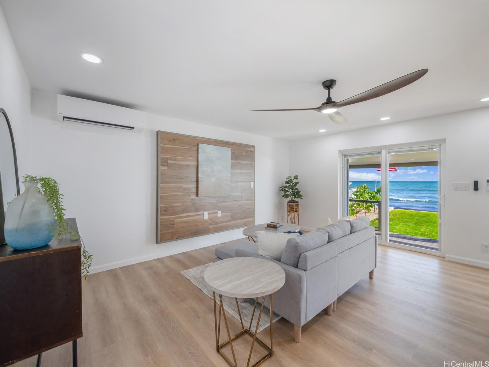 91-481 Ewa Beach Road, Unit C Ewa Beach, HI 96706 - Photo 4 of 25 a living room with furniture and a wooden floor