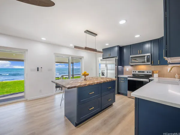 a kitchen with a stove a sink and a refrigerator
