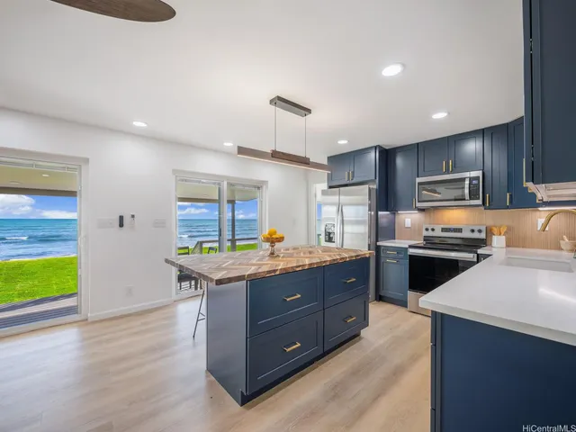 a kitchen with a stove a sink and a refrigerator