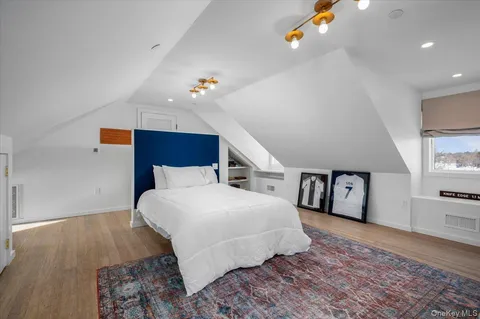 a spacious bedroom with a bed and a dresser