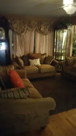 a living room with furniture and a chandelier