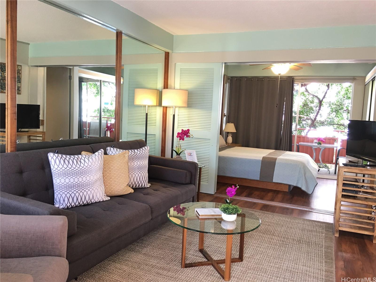 417 Nohonani Street, Unit 402 Honolulu, HI 96815 - Photo 1 of 1 a living room with furniture and a large window