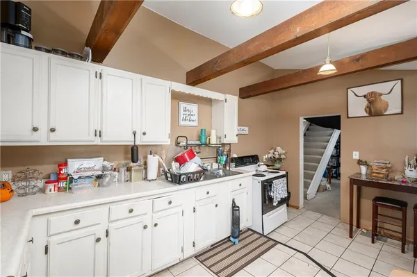 a kitchen with cabinets stainless steel appliances and a sink