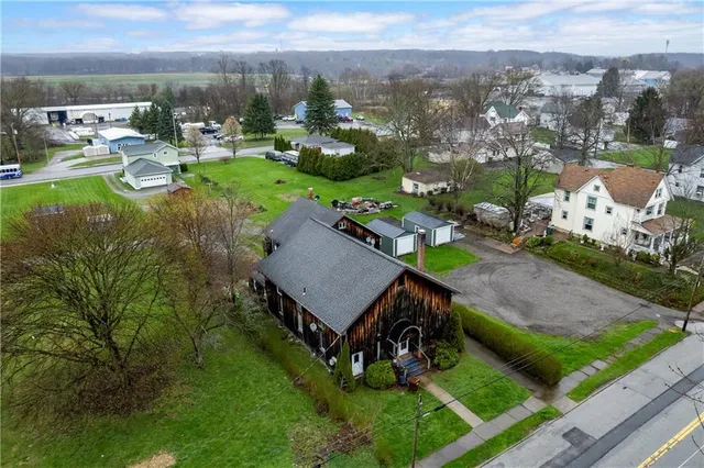 an aerial view of a house with garden space and lake view
