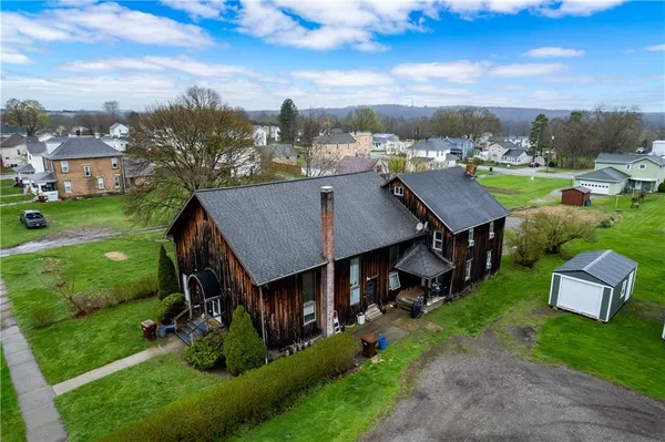 an aerial view of a house with a garden and trees