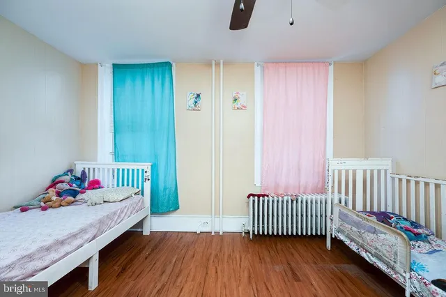 a bedroom with furniture and baby crib