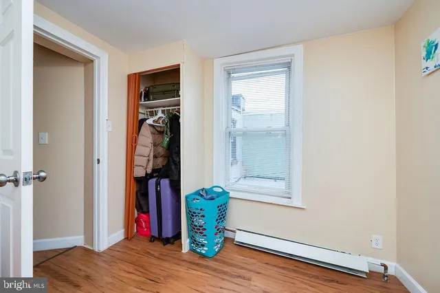 a view of hallway with wooden floor and stairs