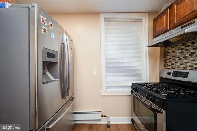 a kitchen with a stove and a refrigerator