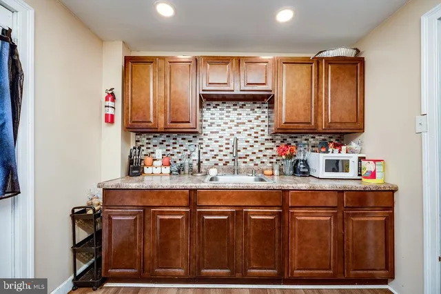 a kitchen with granite countertop a sink and cabinets