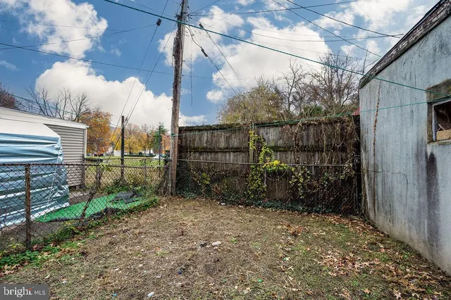 a view of a chairs and table in the back yard of the house