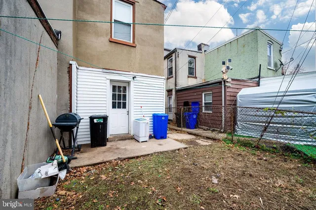a view of a house with a patio and a yard