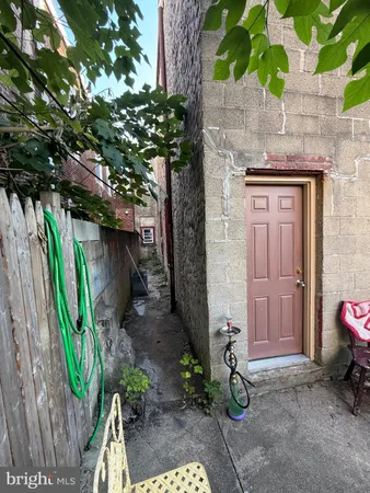 a backyard of a house with barbeque oven table and chairs