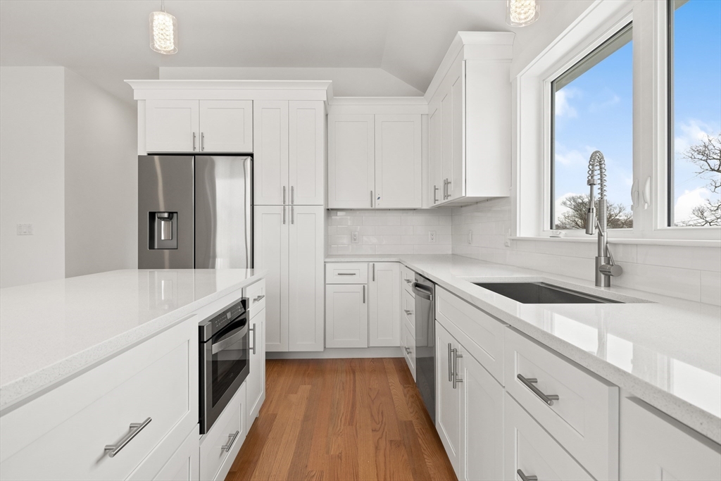 2 Old County Road, Unit 10 Salisbury, MA 01952 - Photo 4 of 27 a kitchen with a sink stove and refrigerator