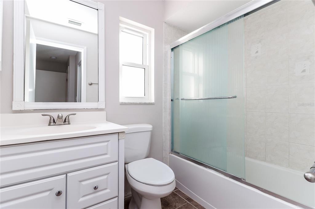 8104 Juarez Drive Port Richey, FL 34668 - Photo 12 of 15 a bathroom with a toilet a sink and a mirror