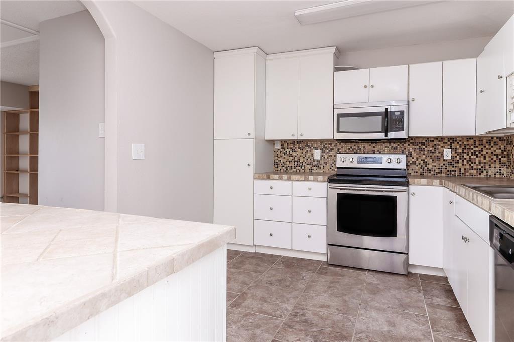 8104 Juarez Drive Port Richey, FL 34668 - Photo 5 of 15 a kitchen with cabinets appliances and a window