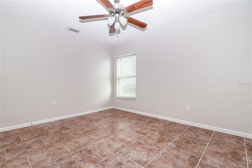 8104 Juarez Drive Port Richey, FL 34668 - Photo 10 of 15 an empty room with a window and a fan