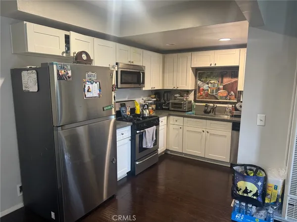a kitchen with stainless steel appliances a refrigerator sink and microwave