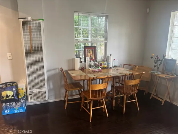 a dining room with furniture and wooden floor