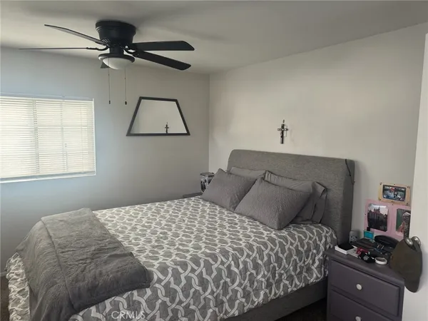 a bedroom with a bed and a window