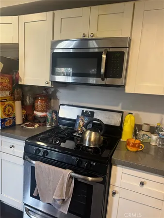 a kitchen with a stove and a microwave