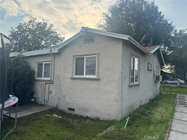 a backyard of a house with table and chairs
