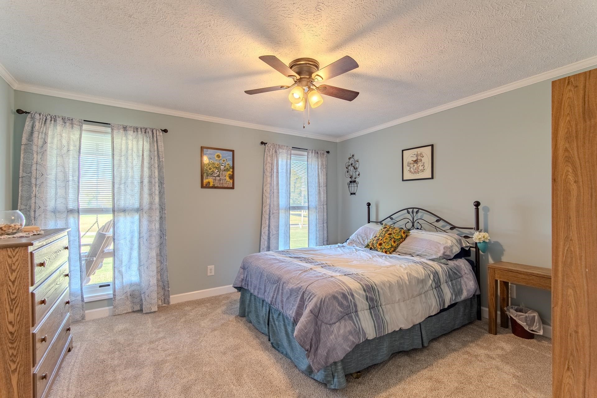 145 Tom Way Savannah, TN 38372 - Photo 16 of 40 a bedroom with a bed and a chandelier
