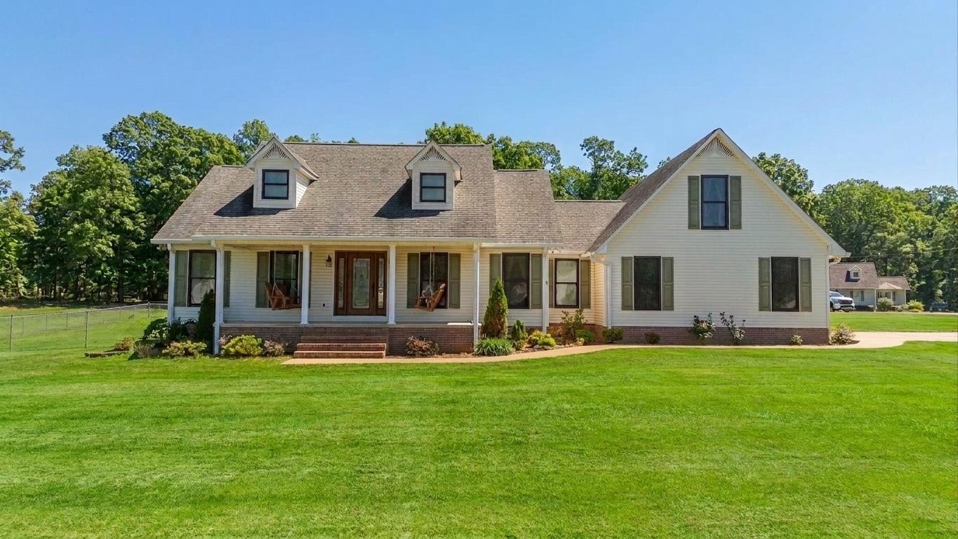 145 Tom Way Savannah, TN 38372 - Photo 2 of 40 a front view of a house with a yard and porch