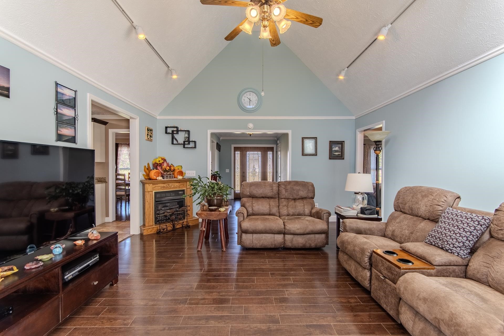 145 Tom Way Savannah, TN 38372 - Photo 5 of 40 a living room with furniture a flat screen tv and a fireplace