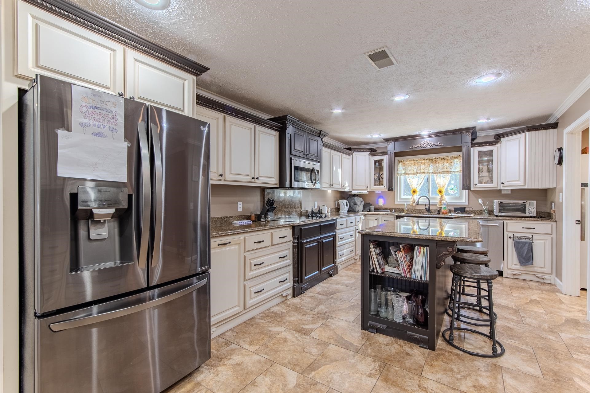 145 Tom Way Savannah, TN 38372 - Photo 6 of 40 a kitchen with granite countertop stainless steel appliances a refrigerator and a stove top oven