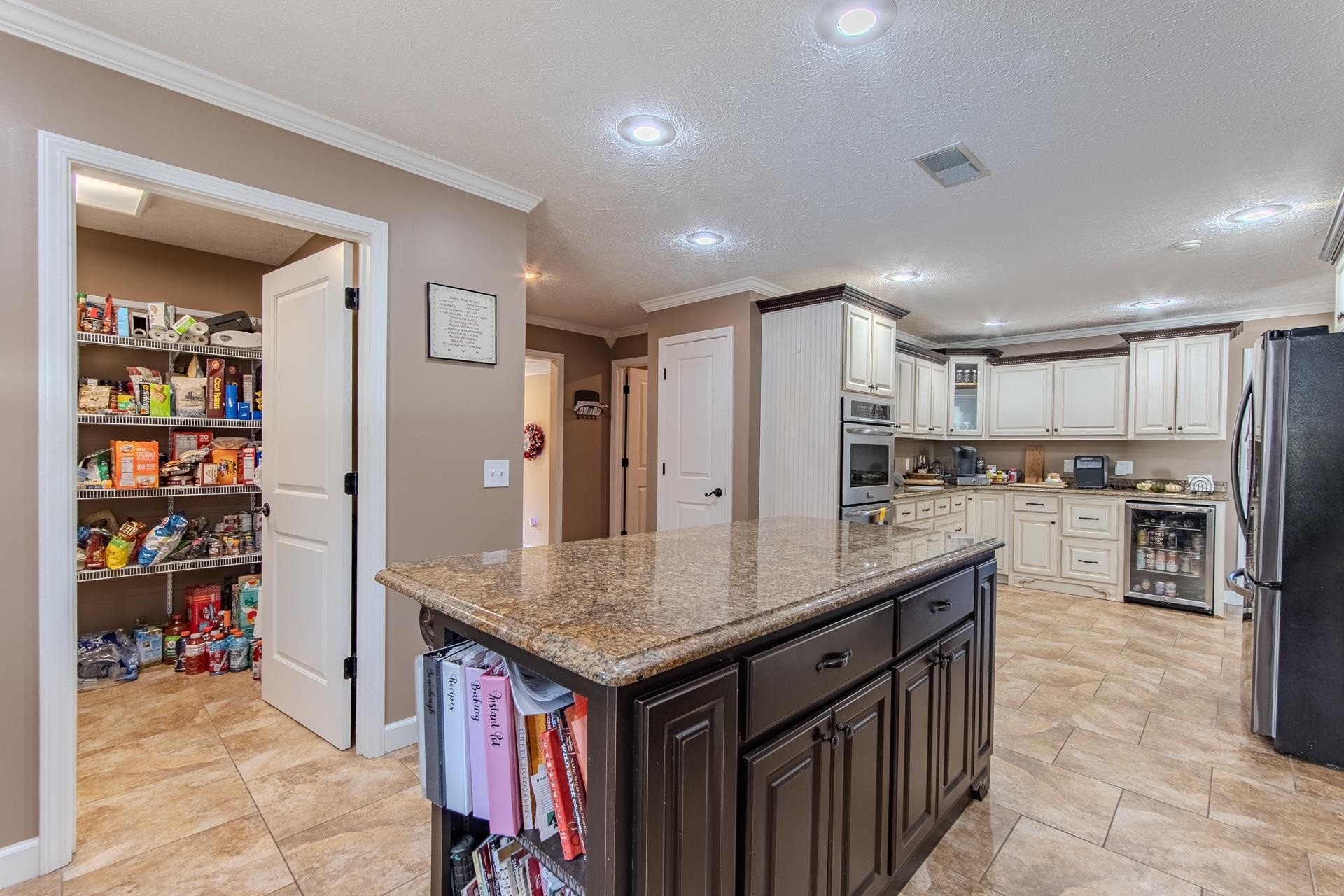145 Tom Way Savannah, TN 38372 - Photo 9 of 40 a kitchen with stainless steel appliances granite countertop a table chairs and a refrigerator