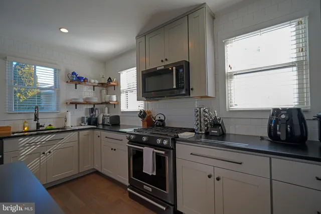 a kitchen with a sink stove and microwave