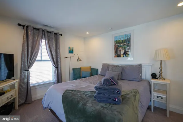 a bedroom with a large bed and a window