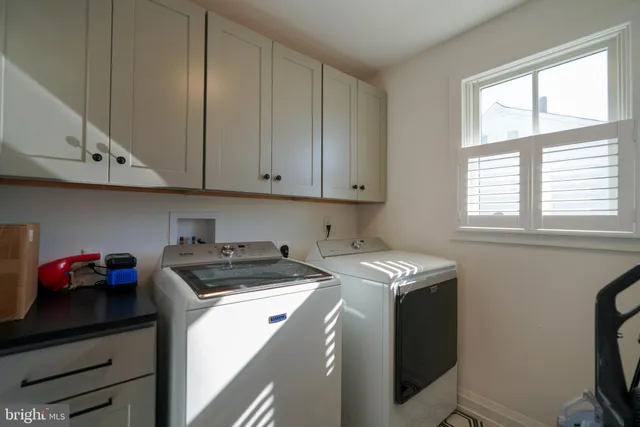 a utility room with sink dryer and washer