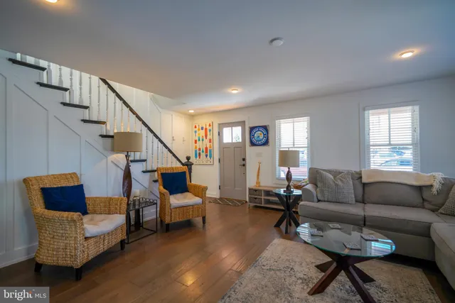 a living room with furniture and stairs