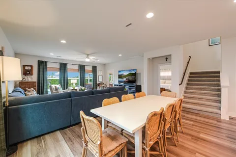 a view of a patio with table and chairs potted plants with wooden floor and fence