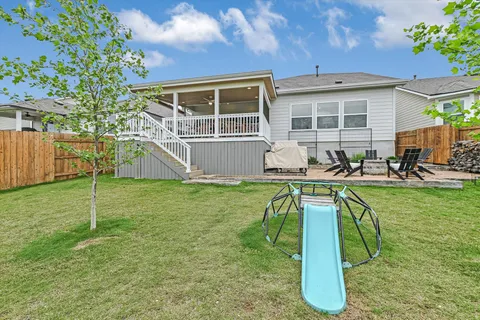 a living room with furniture a large window and chandelier