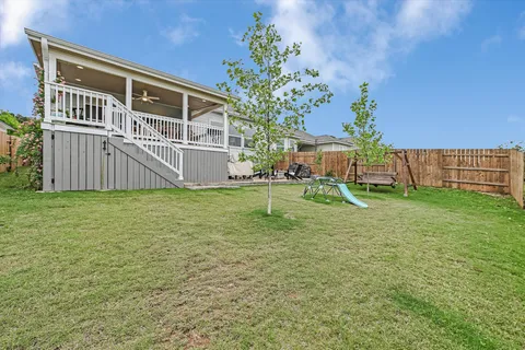 a swimming pool with outdoor seating and yard