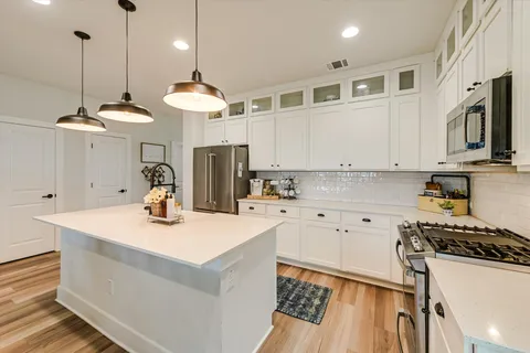 a bed room with a bed and painting on the wall