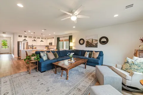 a living room with furniture a fireplace and a flat screen tv