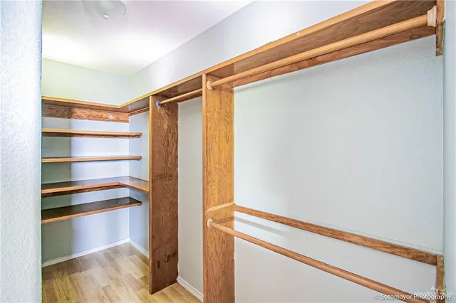 a view of walk in closet with empty racks