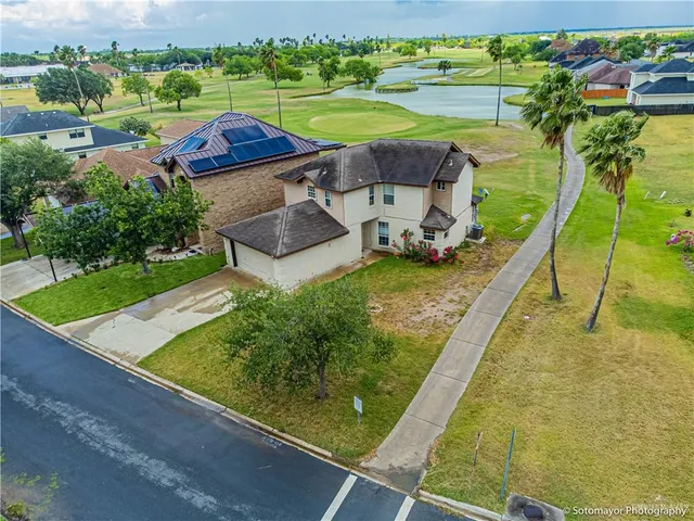 an aerial view of a house with a big yard