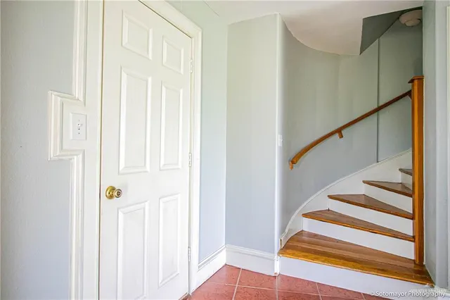 a view of a livingroom with wooden floor and stairs