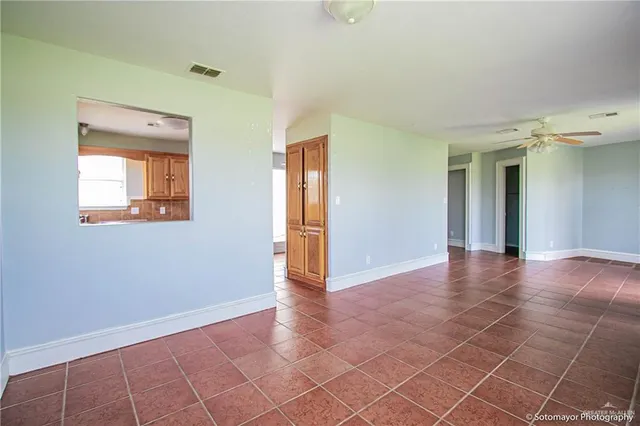 an empty room with windows and closet