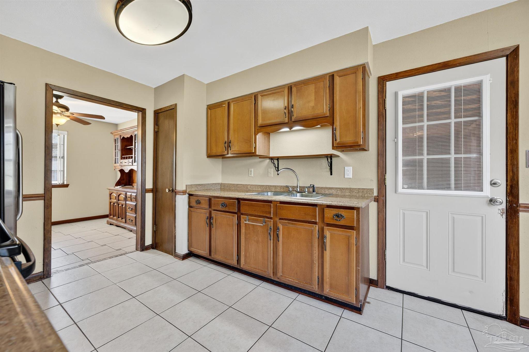 1120 Muscogee Road Cantonment, FL 32533 - Photo 14 of 38 a kitchen with stainless steel appliances granite countertop a sink and cabinets