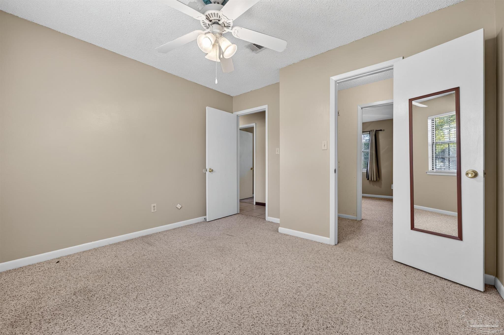 1120 Muscogee Road Cantonment, FL 32533 - Photo 16 of 38 a view of an empty room with a window