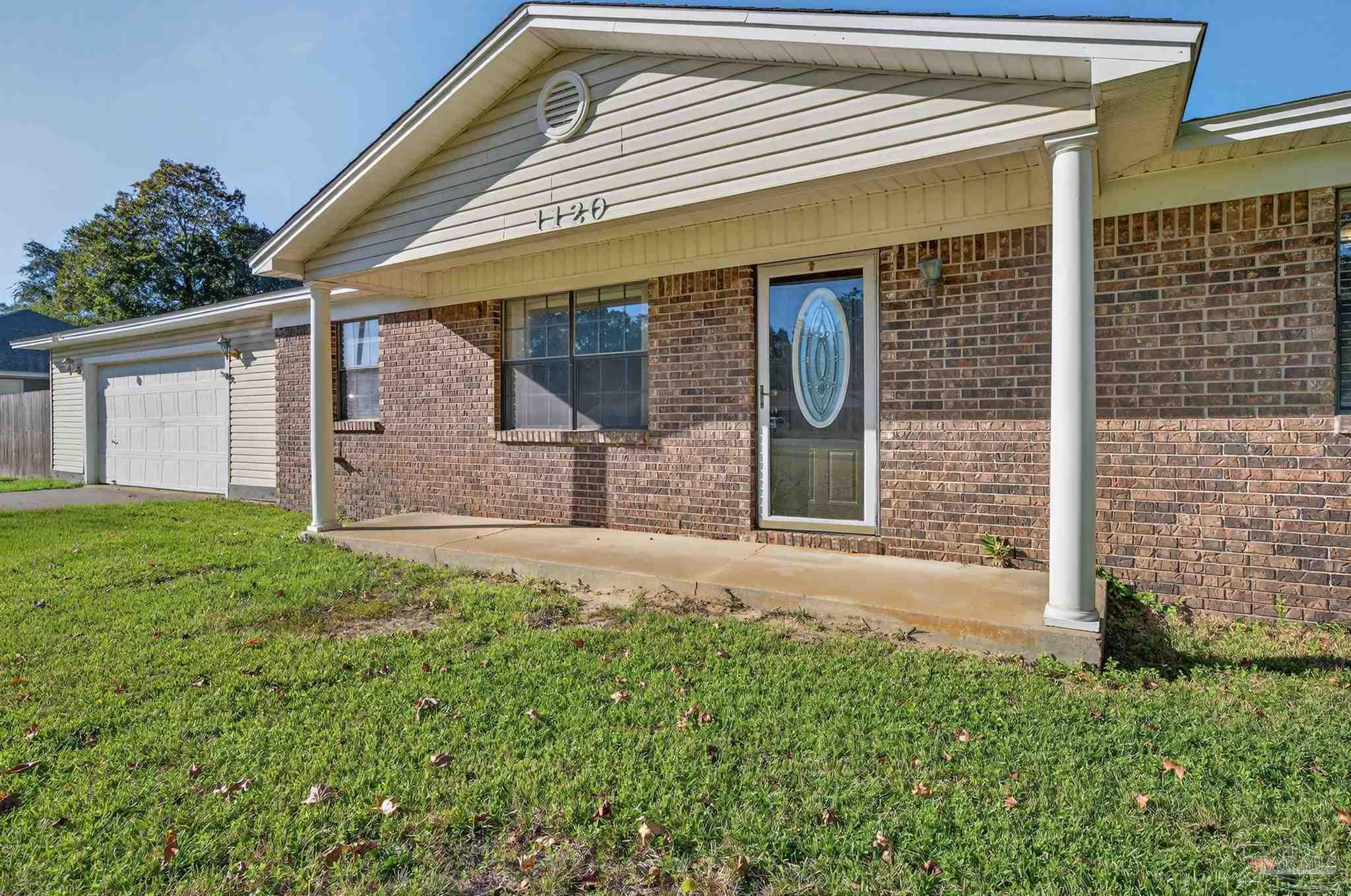 1120 Muscogee Road Cantonment, FL 32533 - Photo 2 of 38 front view of a house with a yard