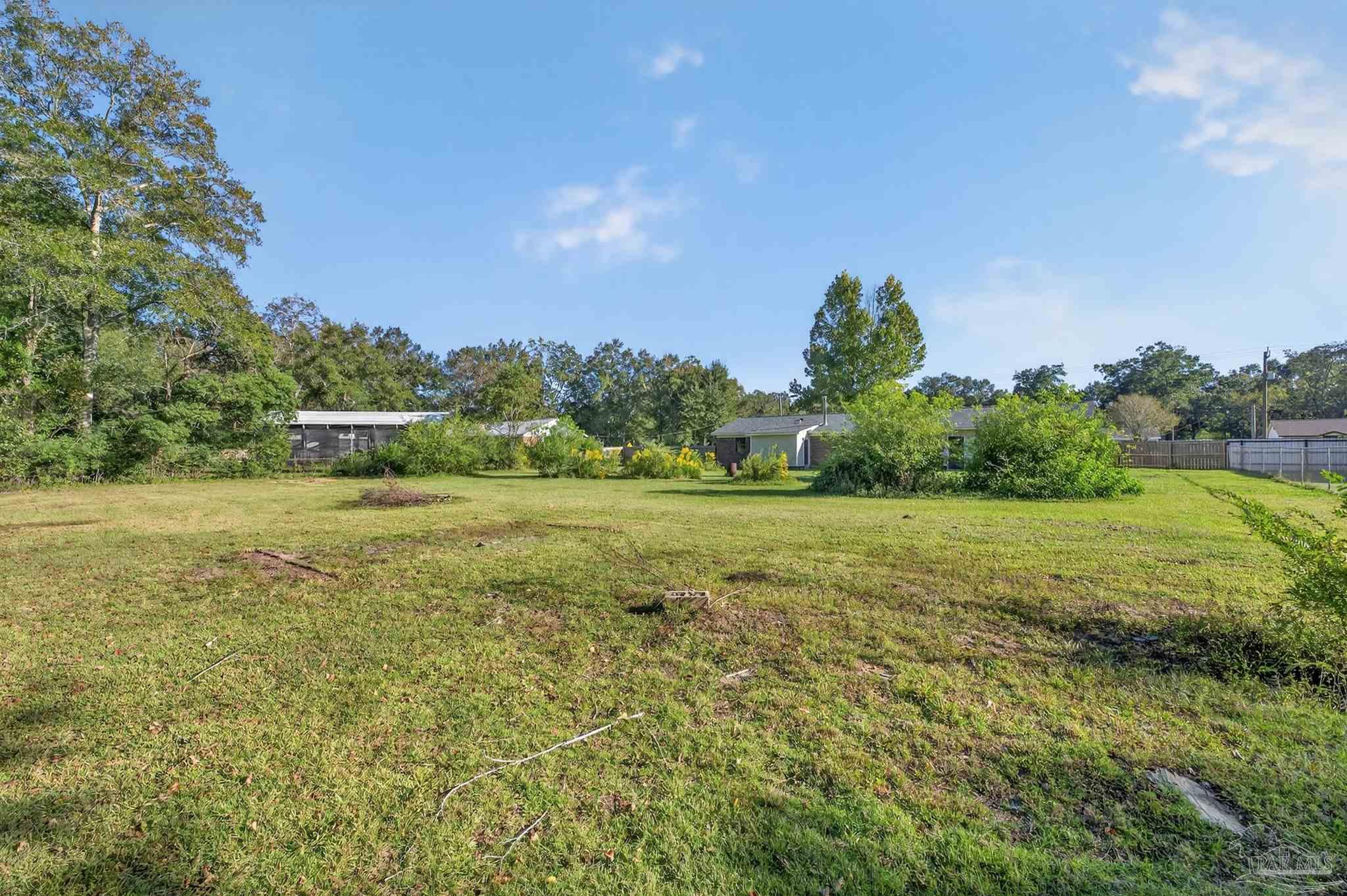 1120 Muscogee Road Cantonment, FL 32533 - Photo 35 of 38 a view of a field with an trees